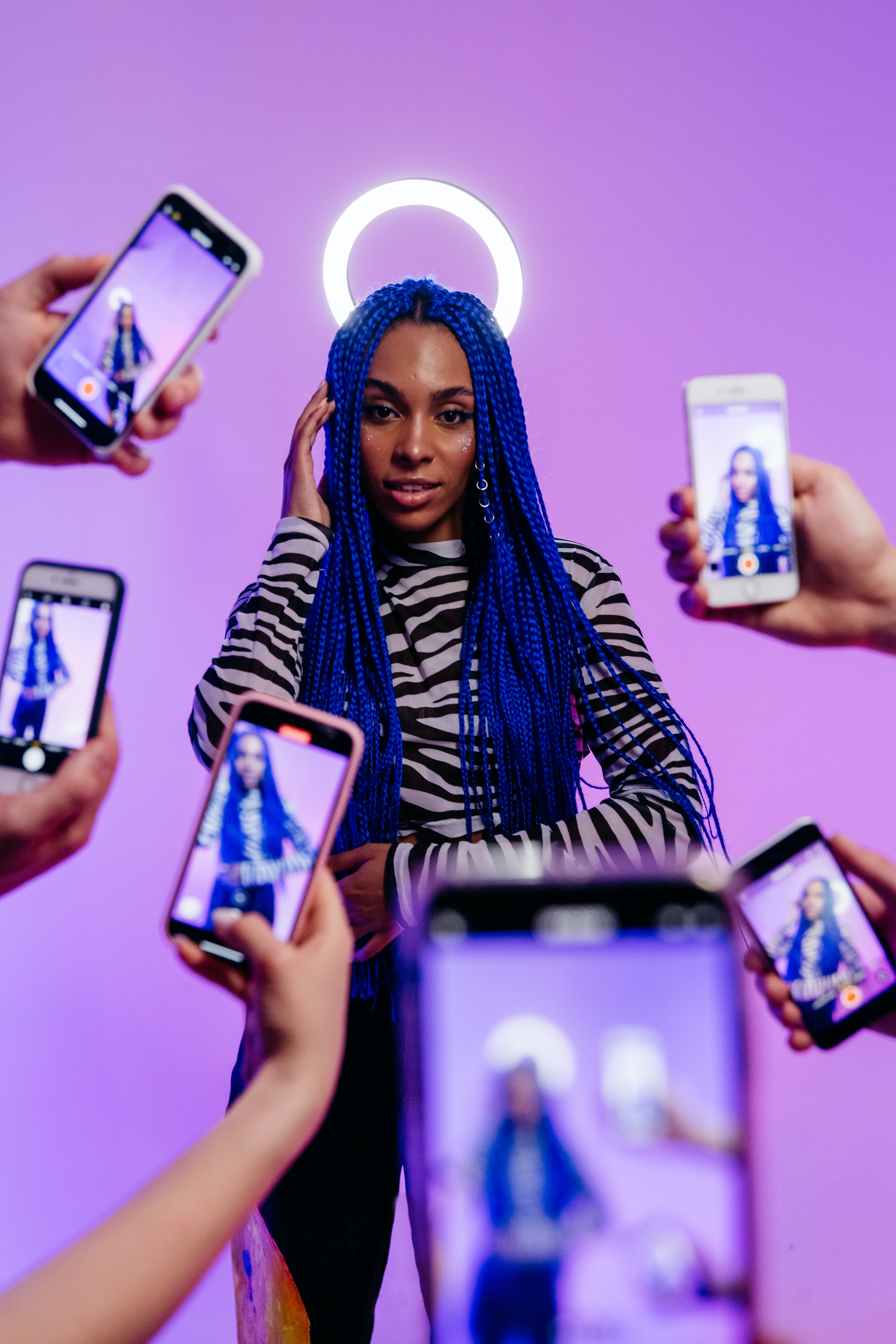 Fashion Influencer posing for pictures purple background