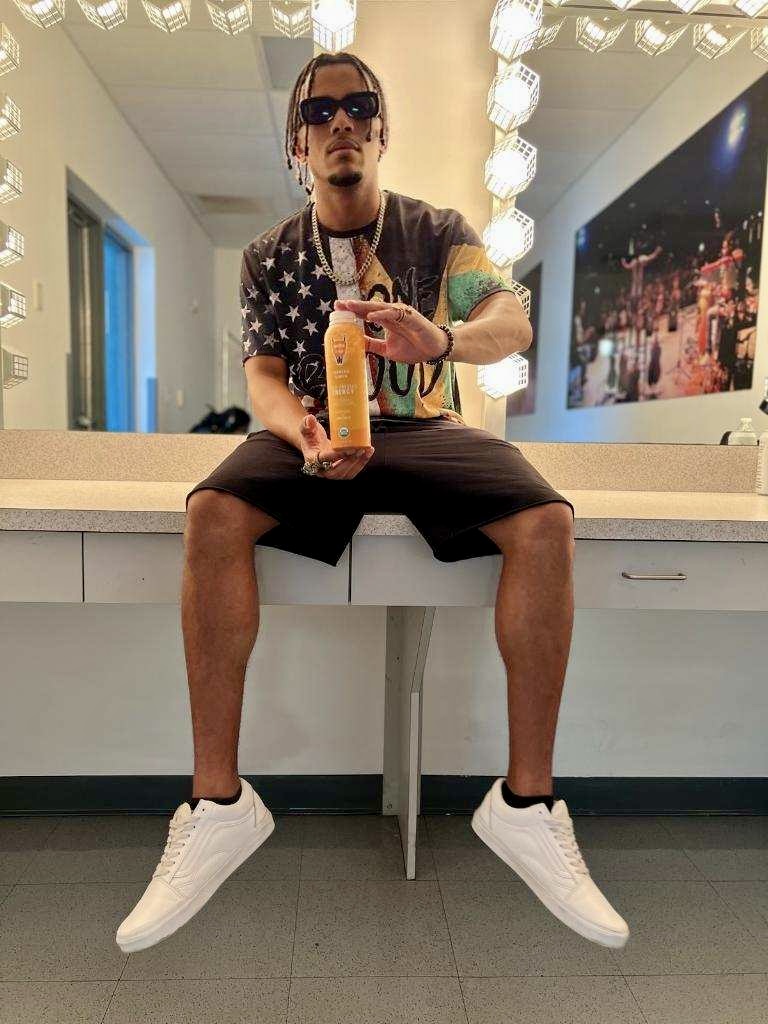 Yung Wylin backstage holding Garden of Flavor energy drink