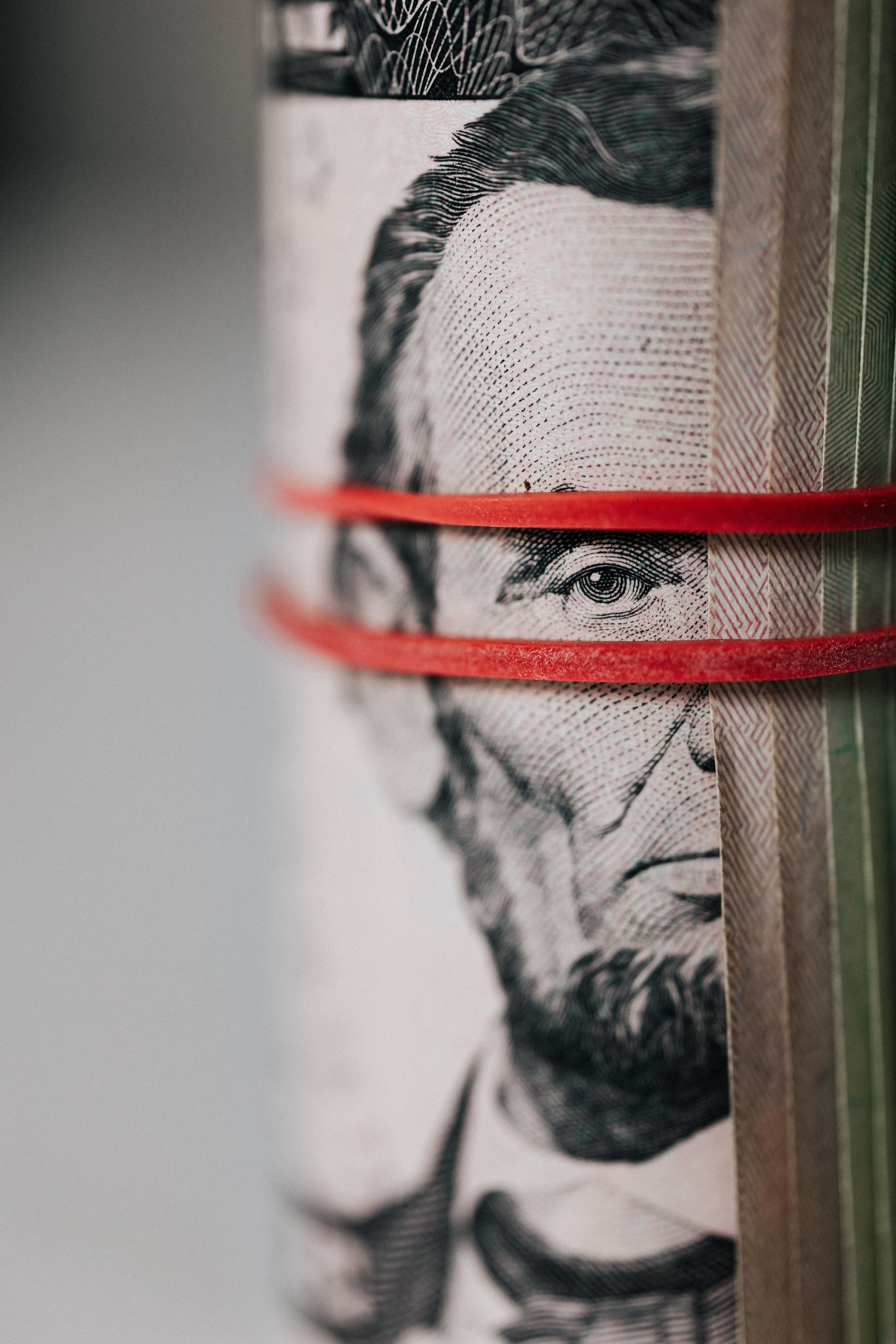 Roll of American dollar banknotes tightened with band Abraham Lincoln
