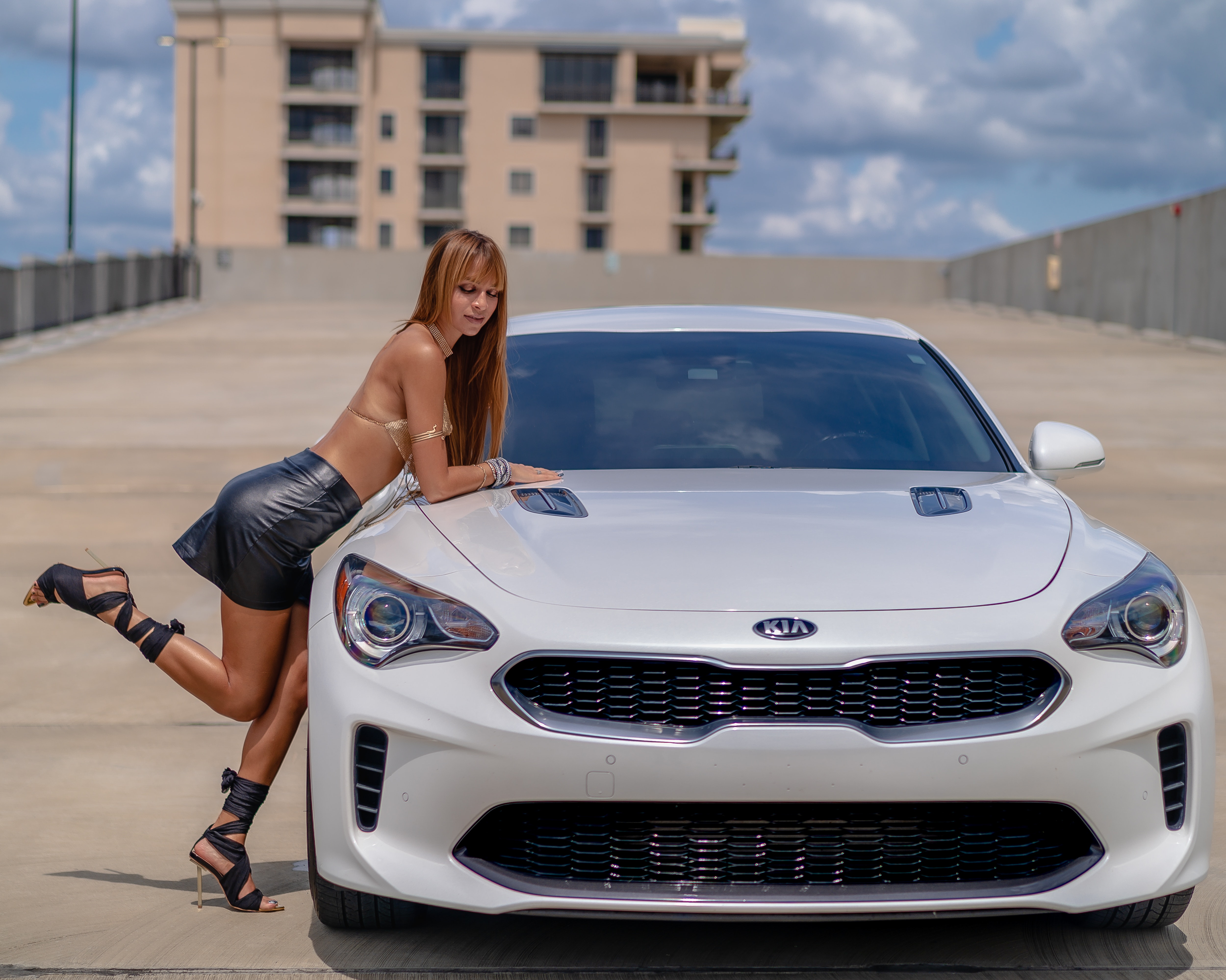 Model laying on Kia Stinger