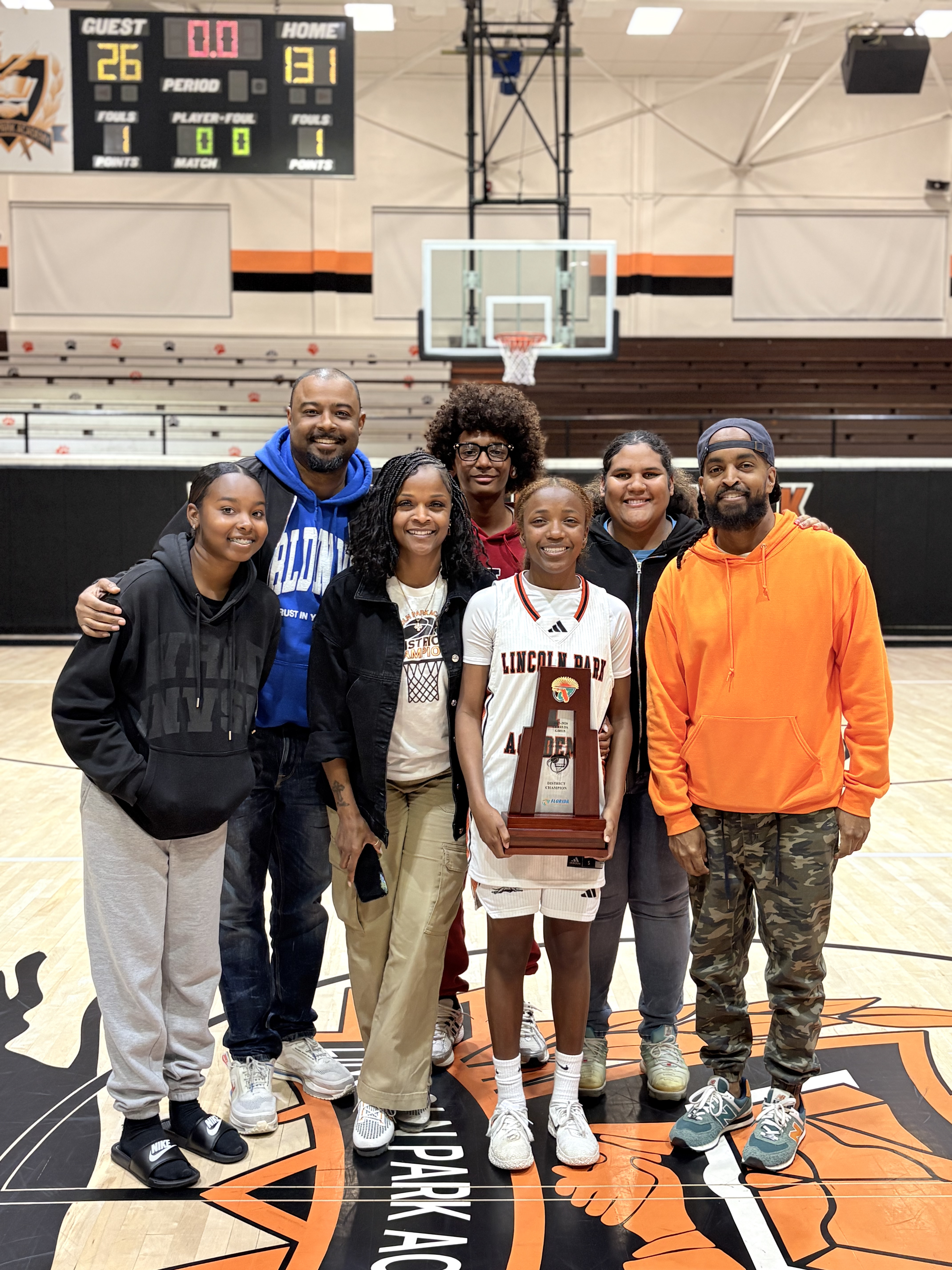 Lincoln Park Academy wins district game 131 to 26. Laylah Dawkins holding trophy. 