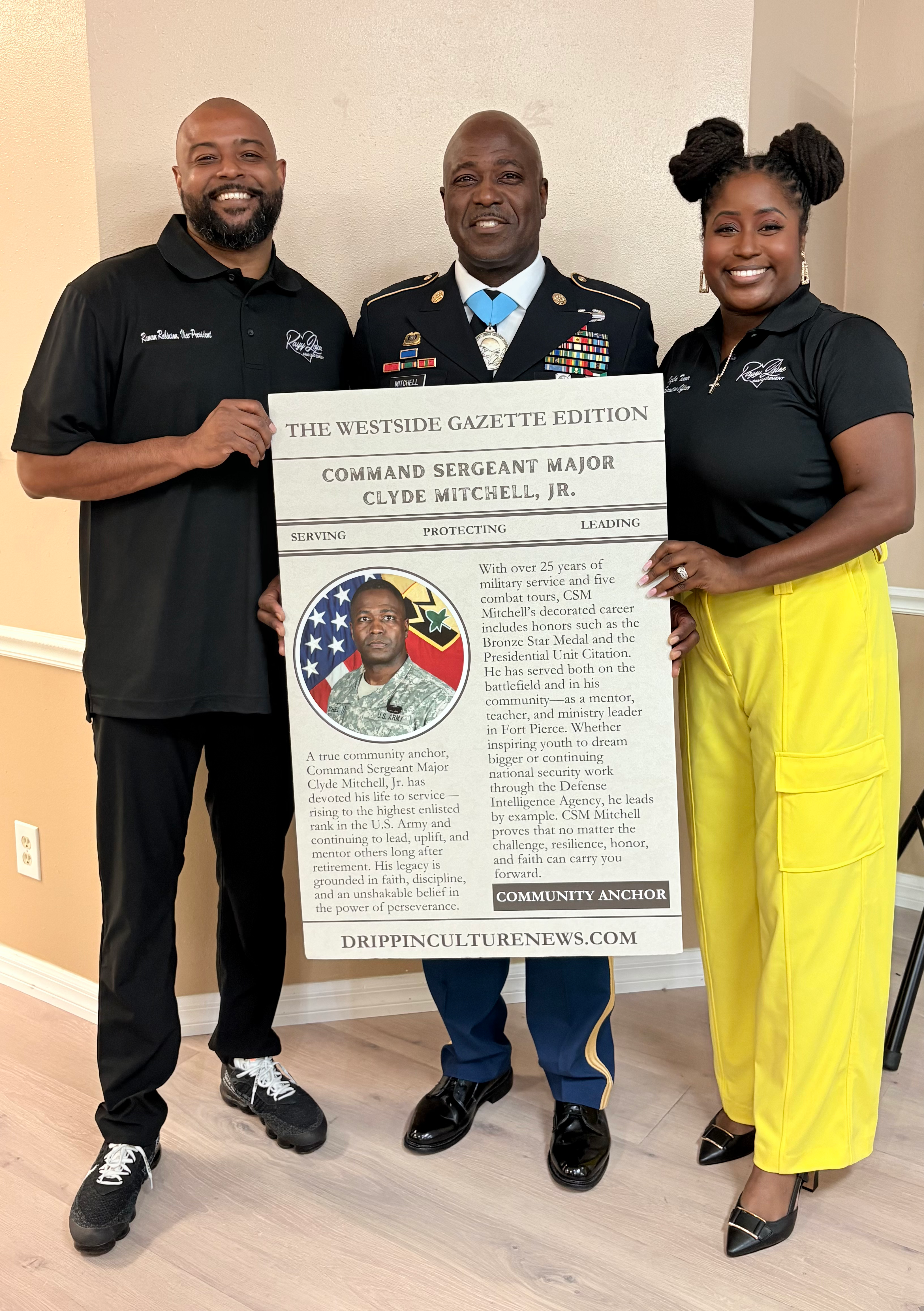 Ramon Robinson and Kalya Turner posing with trading card recipient Command Sergeant Major Clyde Mitchell, Jr.