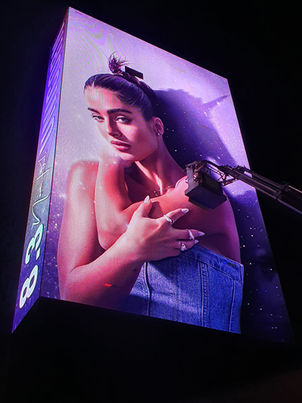 Noa Kirel’s Unicorn campaign for the Eurovision Song Contest 2023, displayed on a giant digital billboard at night. Concept and design by Shine Horovits. קמפיין Unicorn של נועה קירל לאירוויזיון 2023, מוצג על מסך דיגיטלי ענק בלילה. קונספט ועיצוב מאת שיין הורוביץ.