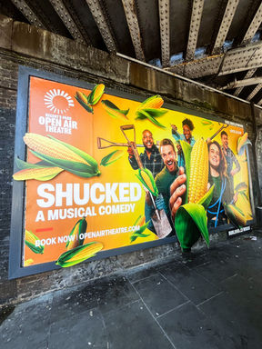 Shucked musical campaign displayed on a large Pop-up outdoor billboard in London.