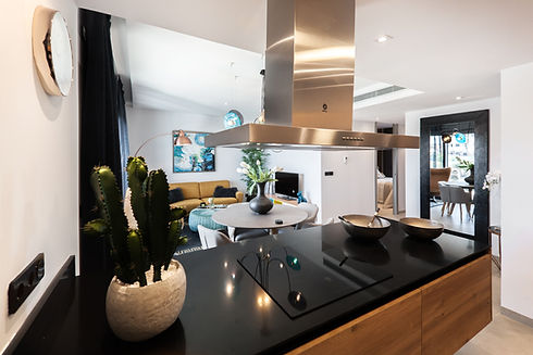 Modern kitchen with stainless steel vent and black countertops