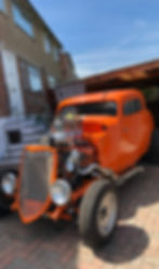 Bright orange custom hotrod built by Jacob Hammersley’s father, photographed outside his family home.