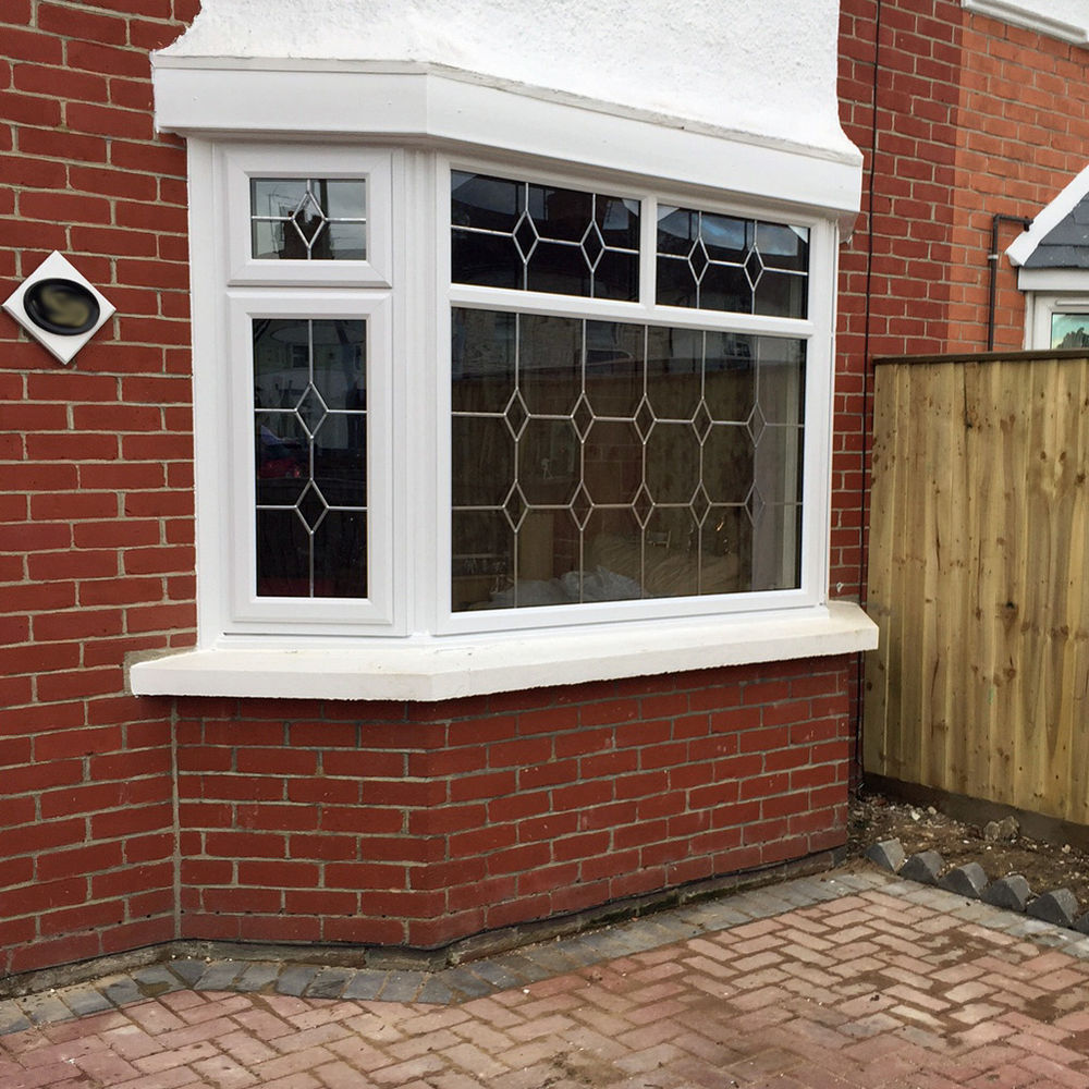 Bay window installation with Queen Anne leaded glass