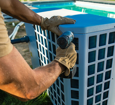 HVAC Technician Installing Pool Heater Near Swimming Pool
