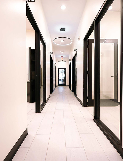 The hallway with open doors of the salon suites at Mosaic Salon Studios Southside