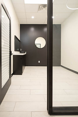 A salon suite with cabinet, sink and mirrors for esthetics at Mosaic Salon Studios Southside
