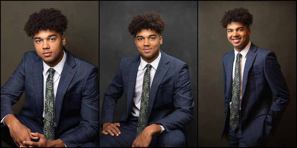 senior photos of guy wearing suit and tie against dark grey background