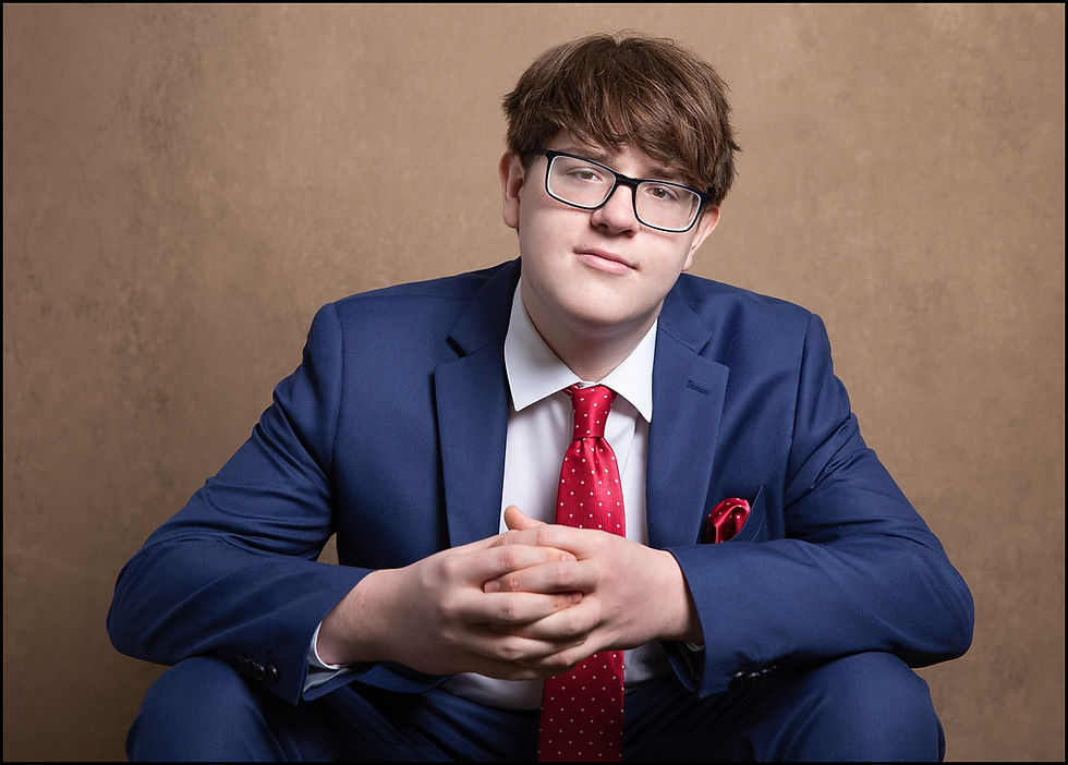 studio senior pictures of upper arlington high school senior guy in suit and tie