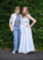 portrait of two sisters during a senior photoshoot in westerville ohio in front of an ivy wall