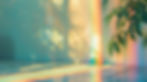 Warm sunlight creates rainbow prisms and plant shadows in a bright, creative workspace