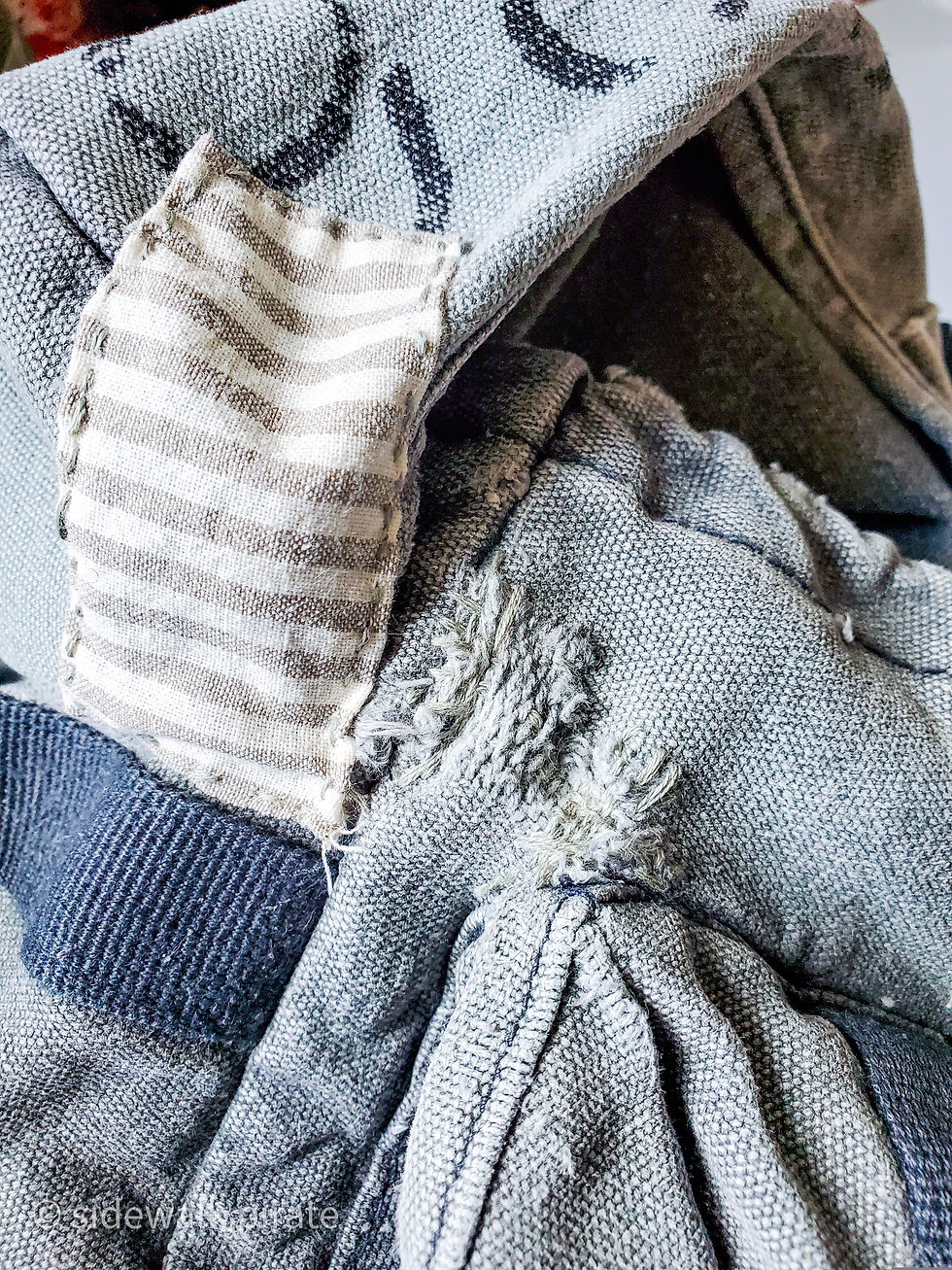 Repaired holes on the top of the backpack. One was fixed by sewing a scrap of striped ticking fabric over it, the other one was fixed by imitating the original backpack weave of the fabric with grey mending thread.