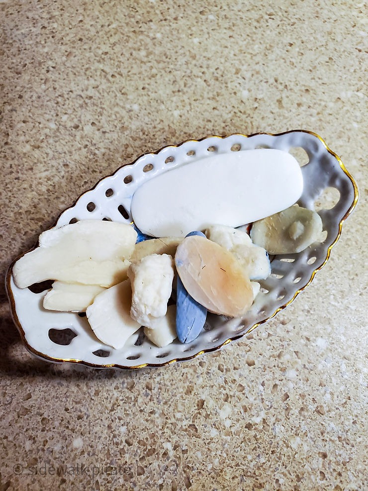 Small dish full of tiny soap slivers