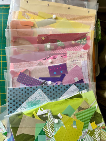 clear plastic pouches spread out to show how each houses one colour of papers