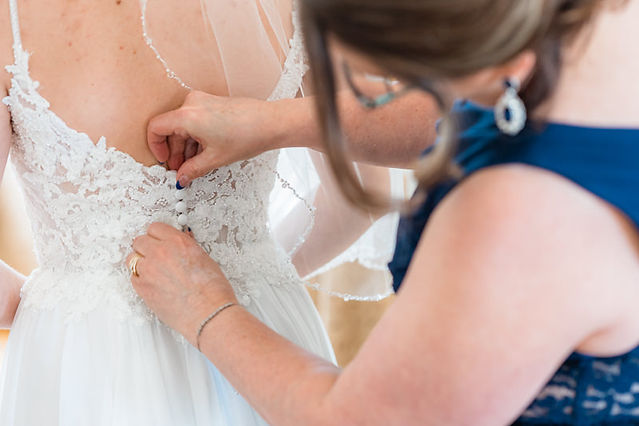 bride getting into wedding dress