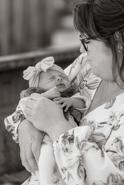 closeup of baby girl face during newborn session (black and white photo)