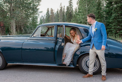 bride and groom in Canmore with Rolls Royce