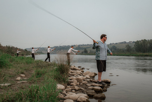 groomsmen fishing before the ceremony