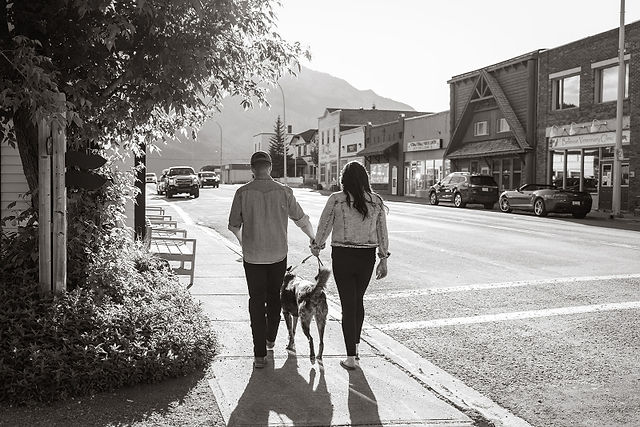 couple and their dog walks down crowsnest pass