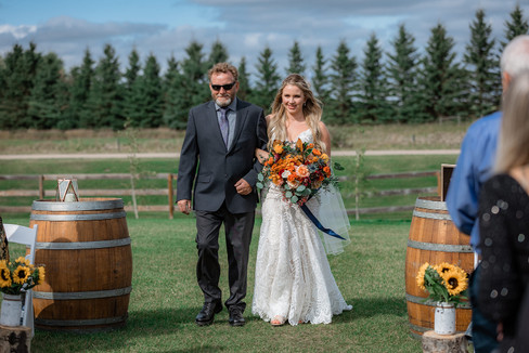 bride walks down the aisle at Pine and Pond