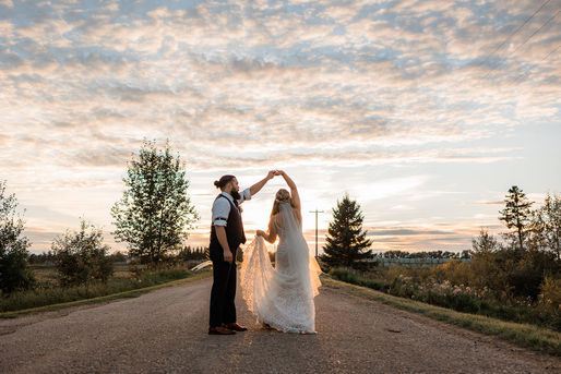 Alberta sunset wedding photos with bride and groom dancing outside