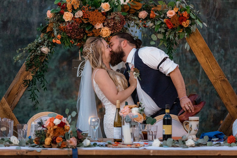 bride and groom kiss at Pine and Pond wedding reception