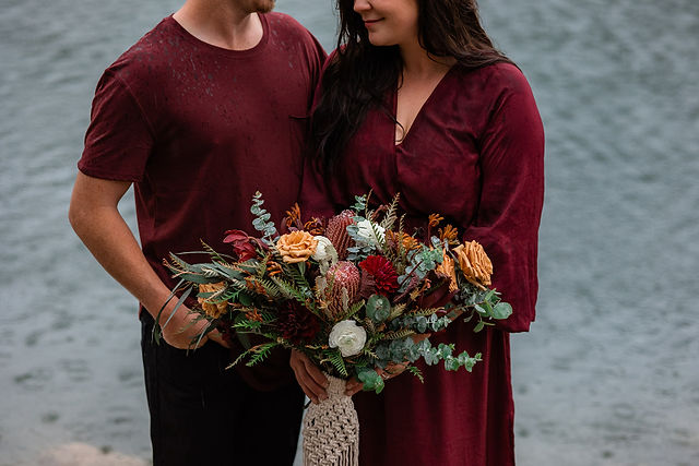 couple adventure photos in front of lake in Crowsnest Pass