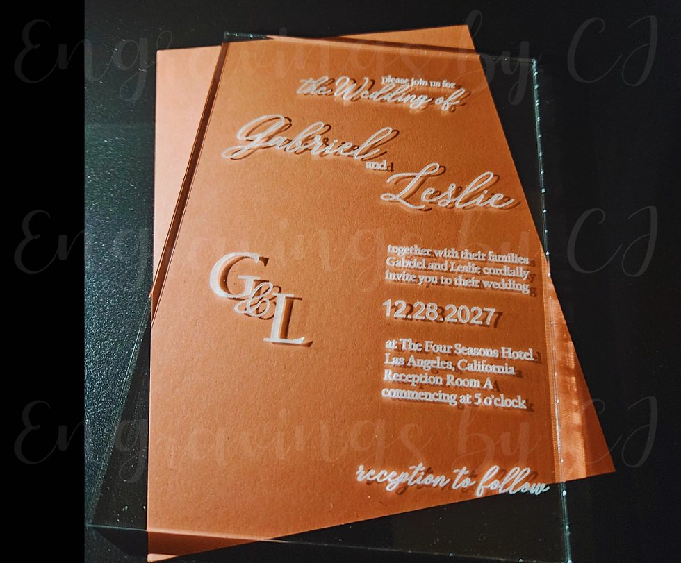 Thumbnail: Clear acrylic wedding invitation featuring couple’s initials and elegant script