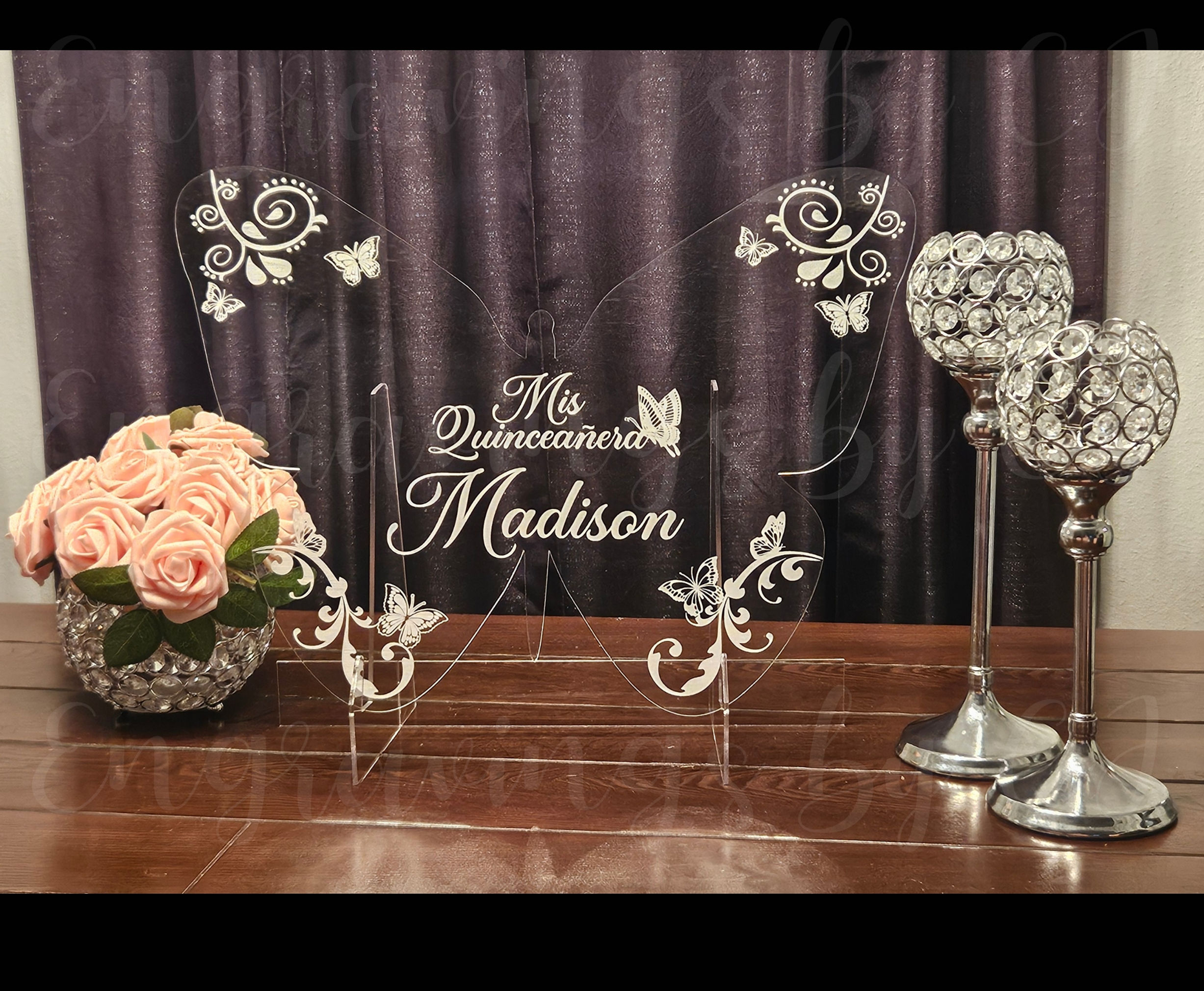 Custom butterfly-shaped acrylic welcome sign with floral and butterfly engravings for Quinceañera