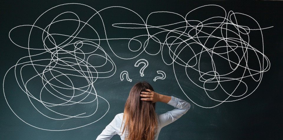 Confused teacher looking at blackboard