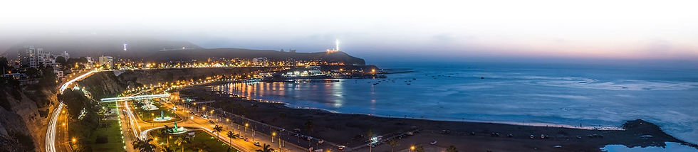 City coastline at night with bright lights illuminating roads and buildings.