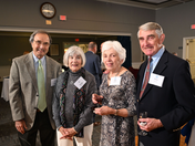 Four guests smiling at the 25th Anniversary celebration.