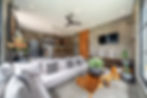 Modern living room with white sofa and kitchen bar in Villa Zayden, Bali.