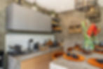 Modern kitchen with concrete counters, wood, tropical flowers