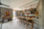 Modern kitchen bar with concrete walls and three stools