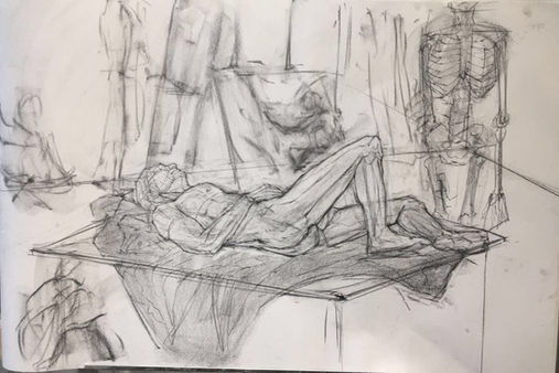 a male figure reclines on a table on top of some sheets. To the right there is a skeleton posed upright. Behind them, wisps of other drawing students are seen. 