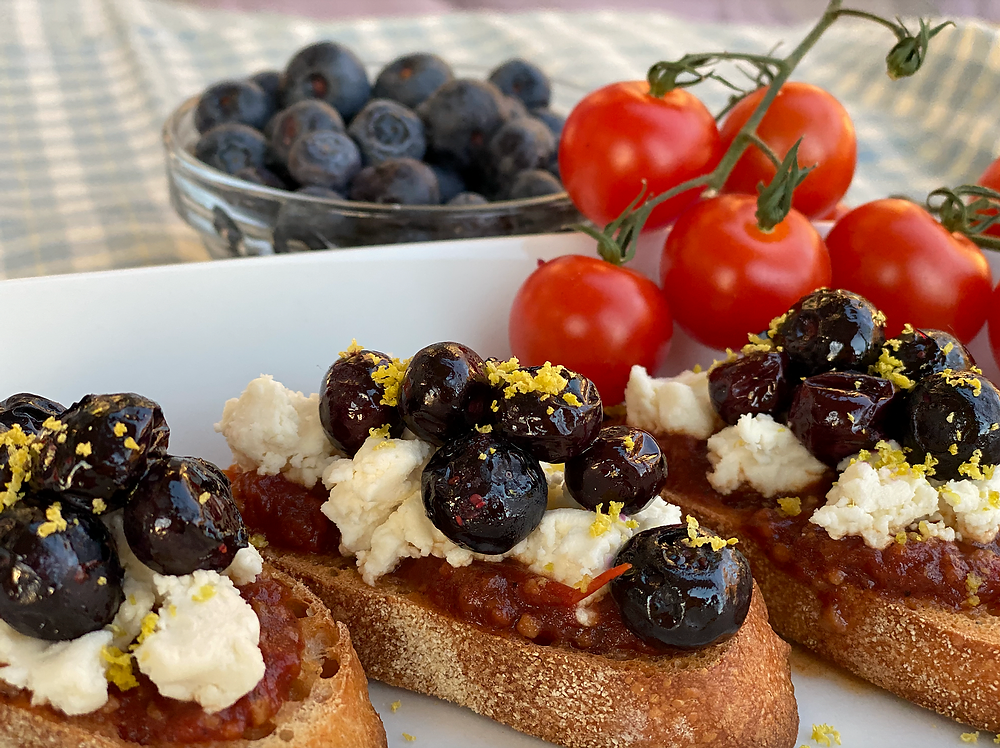 Goat cheese crostini with roasted blueberries and tomato jam