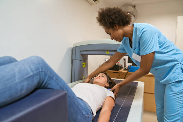 Eye-level view of a medical professional preparing a patient for a DEXA scan