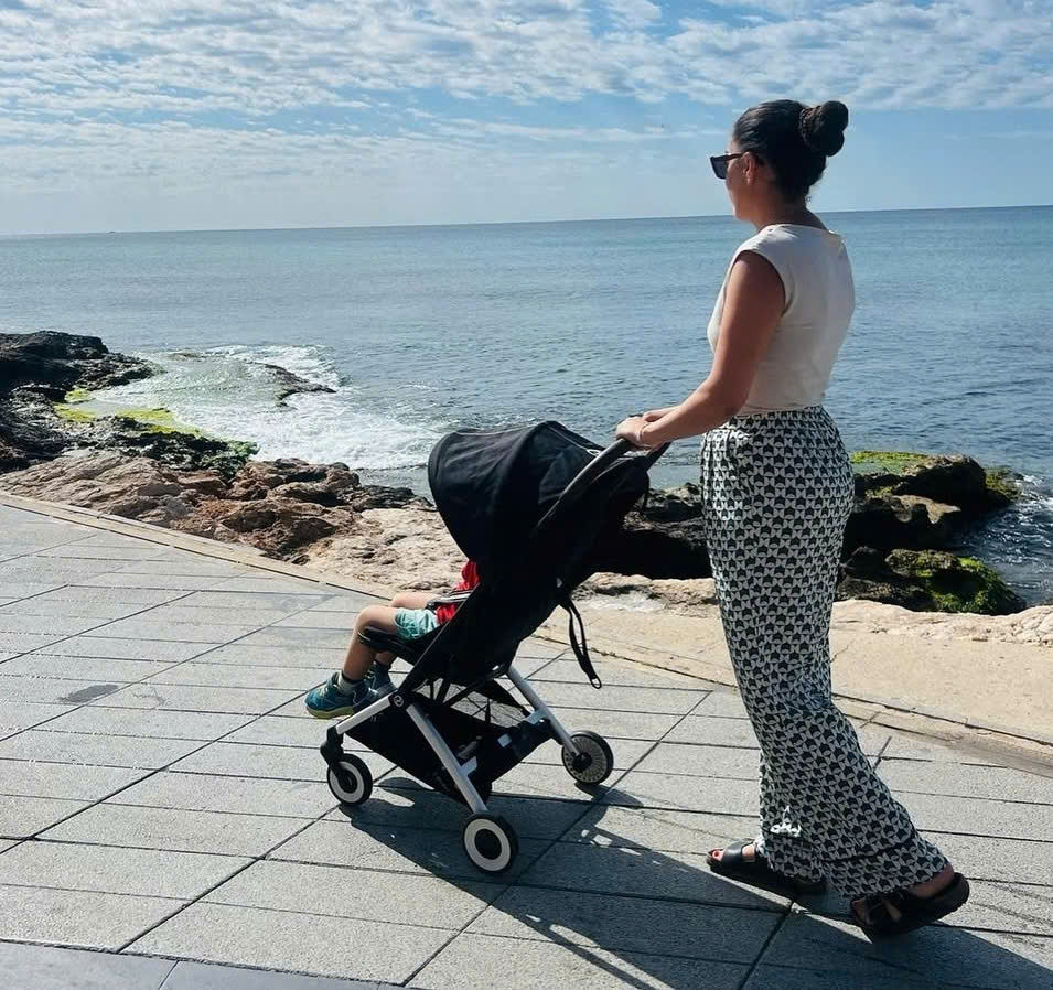 Compact travel stroller on Nha Trang beachfront promenade ideal for babies and toddlers in Vietnam
