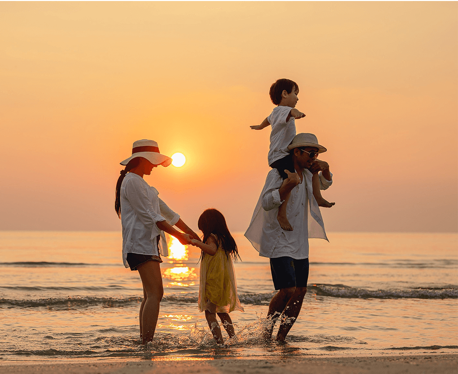 Families walking along My Khe Beach in Da Nang Vietnam
