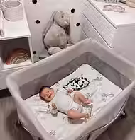 Baby crib set up in a Hanoi hotel room for families traveling with infants