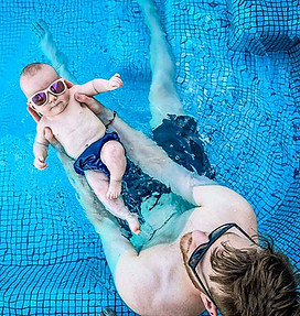 Family with a baby in a resort swimming pool in Da Nang Vietnam enjoying a safe and relaxing tropical holiday at a beachfront hotel with calm water