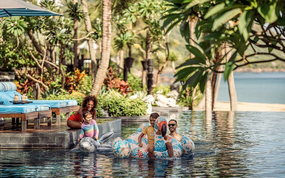 Parents and toddlers tasting local Vietnamese food in a Hanoi lakeside restaurant