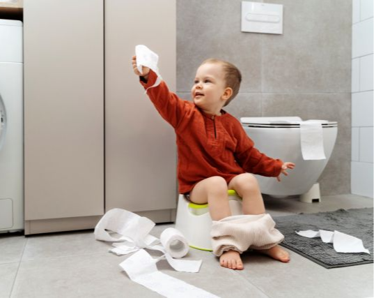 Toddler using a portable potty while traveling in Vietnam with parents nearby for support
