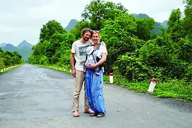 Parents enjoying Vung Tau walk with baby in carrier
