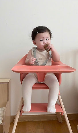 Baby using high chair rental in Hoi An villa during mealtime on family holiday