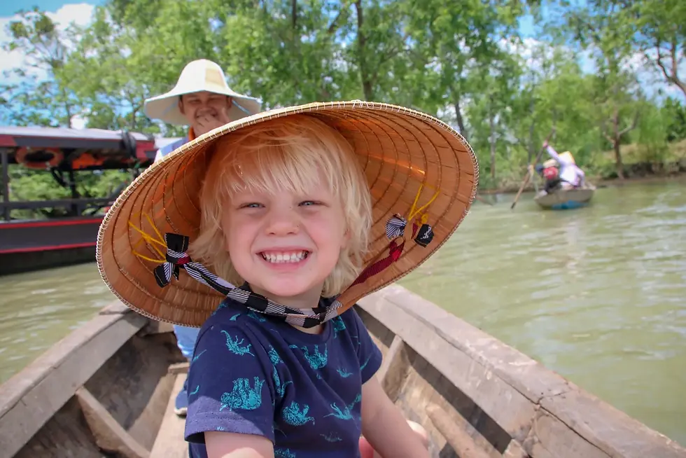 Family on Ninh Binh boat tour with baby in carrier
